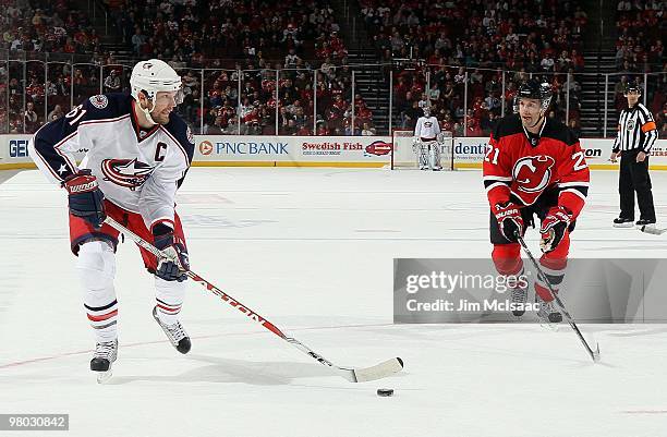 Rick Nash of the Columbus Blue Jackets skates against Rob Niedermayer of the New Jersey Devils at the Prudential Center on March 23, 2010 in Newark,...