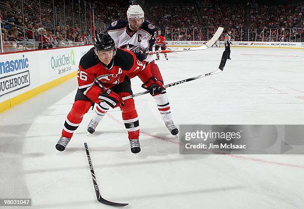 Patrik Elias of the New Jersey Devils skates against Rick Nash of the Columbus Blue Jackets at the Prudential Center on March 23, 2010 in Newark, New...