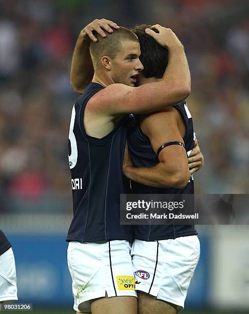 Lachie Henderson of the Blues celebrates a goal with Jarrad Waite during the round one AFL match between the Richmond Tigers and Carlton Blues at...