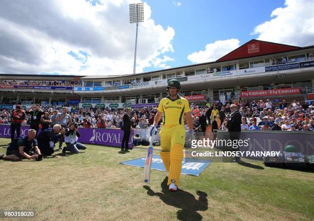 Australia's Aaron Finch and Australia's Travis Head take to the field to open batting on the fourth One Day International cricket match between...
