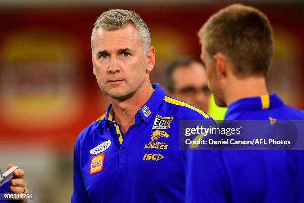 Adam Simpson, coach of the Eagles talks with his staff during the 2018 AFL round 14 match between the West Coast Eagles and the Essendon Bombers at...