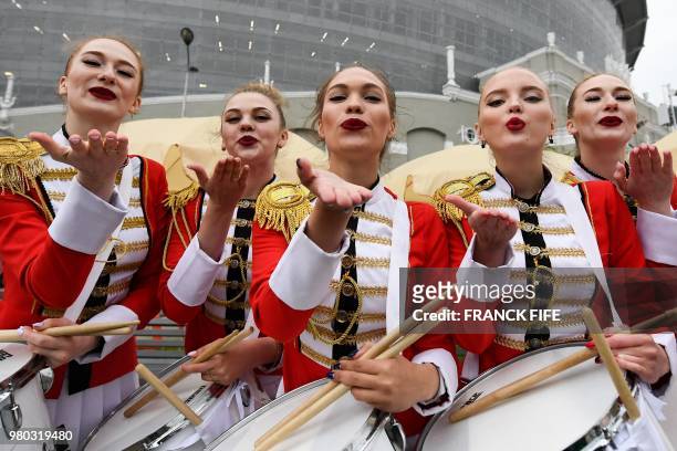 Majorettes pose with their drums upon their arrival with teams fans at the stadium to attend the Russia 2018 World Cup Group C football match between...