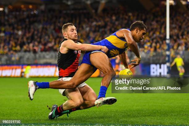 Lewis Jetta of the Eagles is tackled by Devon Smith of the Bombers during the 2018 AFL round 14 match between the West Coast Eagles and the Essendon...