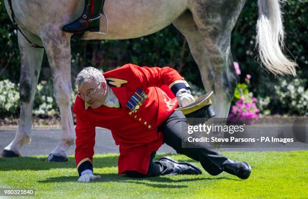 Footman falls over in the parade ring during the carriage procession where Queen Elizabeth II arrives on day three of Royal Ascot at Ascot Racecourse.