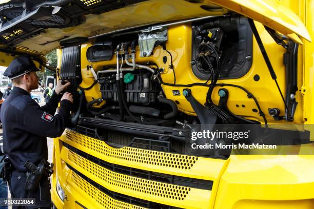 Police officer checks a truck that drove down Stresemannstrasse, a street where the city recently banned older model diesel trucks on June 21, 2018...