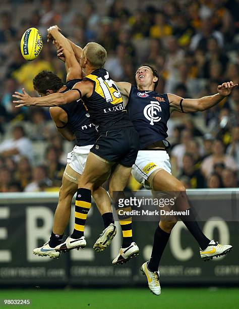 Marc Murphy and Ryan Houlihan of the Blues are spoiled in a marking contest by Mitch Farmer of the Tigers during the round one AFL match between the...