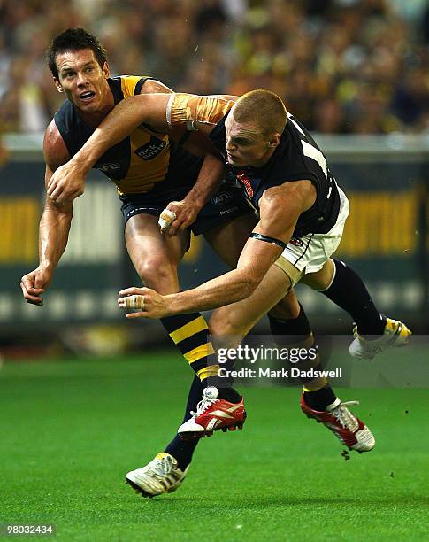 Ben Cousins of the Tigers is tackled by Mitch Robinson of the Blues during the round one AFL match between the Richmond Tigers and Carlton Blues at...