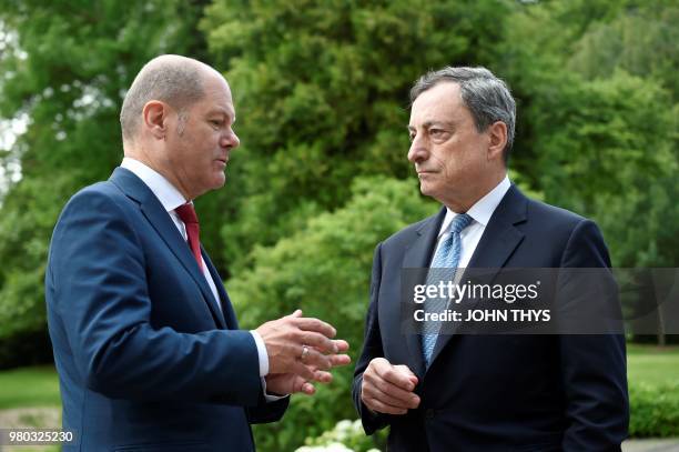 German Finance Minister Olaf Scholz talks with European Central Bank President Mario Draghi during a Eurogroup meeting at Senningen Castle in...