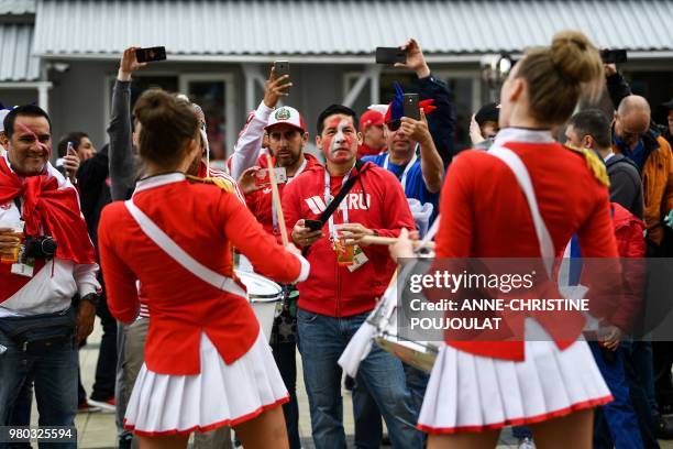 Peru's fans listen to a group of majorettes playing the drum at the stadium's entrance prior to the Russia 2018 World Cup Group C football match...