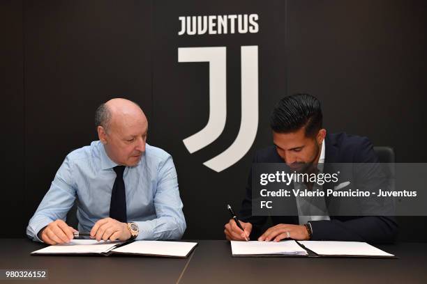 Emre Can and Giuseppe Marotta are seen during the signing of a contract with Juventus at Juventus headquarters on June 21, 2018 in Turin, Italy.