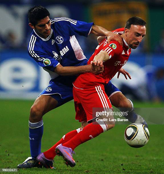 Carlos Zambrano of Schalke challenges Franck Ribery of Muenchen during the DFB Cup semi final match between FC Schalke 04 and FC Bayern Muenchen at...