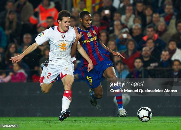 Seydou Keita of FC Barcelona competes for the ball with Azpilicueta of Osasuna during the La Liga match between Barcelona and Osasuna at the Camp Nou...