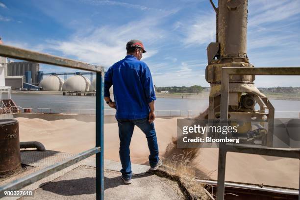 Worker watches as cargo ship Kelly C is loaded with wheat grain at the Lecureur SA cereal plant on the banks of the River Seine at the Port of Rouen...
