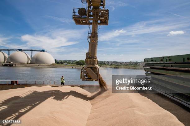 Discharge spout feeds wheat grain into the hull of cargo ship Kelly C at the Lecureur SA cereal plant on the banks of the River Seine at the Port of...