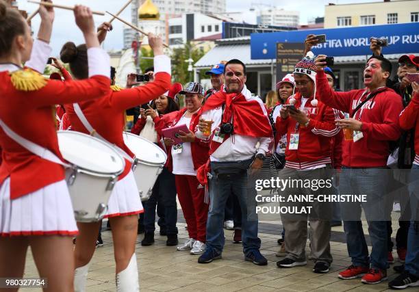 Peru's fans listen to a group of majorettes playing the drum at the stadium's entrance prior to the Russia 2018 World Cup Group C football match...