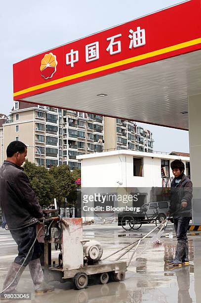 Workers refurbish a PetroChina Co. Gas station in Shanghai, China, on Thursday, March 25, 2010. PetroChina Co., the world's biggest company by market...