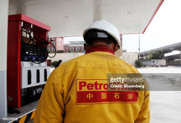 The PetroChina Co. Logo is seen on the back of a worker's uniform at one of the company's gas stations in Shanghai, China, on Thursday, March 25,...