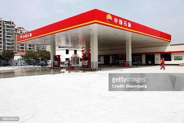 Workers refurbish a PetroChina Co. Gas station in Shanghai, China, on Thursday, March 25, 2010. PetroChina Co., the world's biggest company by market...