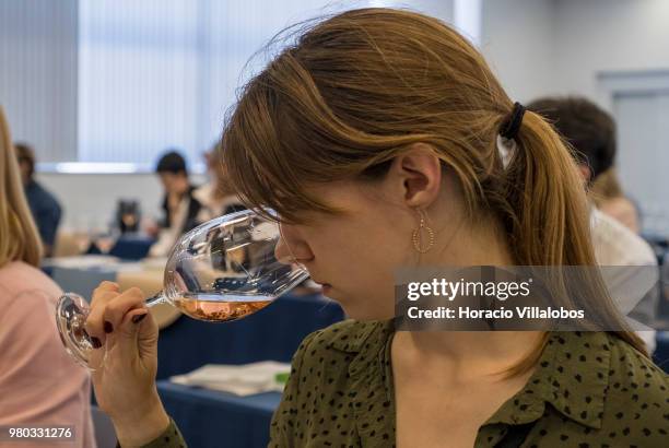 Participants evaluate rose wine during "Taste The Difference" session presenting the same wine, bottled on the same day, under the same conditions,...