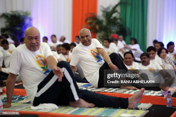 Indian President Ram Nath Kovind and Suriname's President Desi Bouterse take part in a yoga class on the 4th International Yoga Day in Paramaribo,...