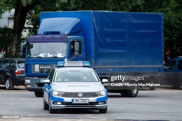 Police car escorts a truck that drove down Stresemannstrasse, a street where the city recently banned older model diesel trucks on June 21, 2018 in...