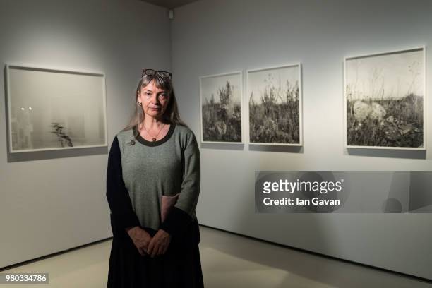Photographer Vanessa Winship poses before her Vanessa Winship: 'And Time Folds' installation view at Barbican Art Gallery on June 21, 2018 in London,...