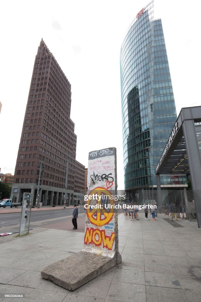 Exterior view of the German Bahn AG headquarters at Pariser Platz in Berlin. In the foreground a single segment of the Berlin Wall.