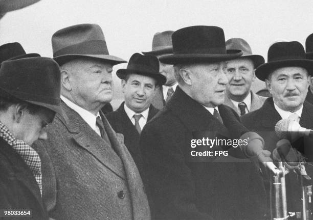 West German Chancellor Konrad Adenauer welcomes former U.S. President Herbert Hoover to Tubingen University in West Germany, 26th November 1954....