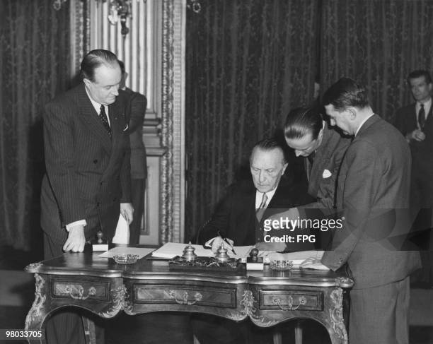 West German Chancellor Konrad Adenauer signs the Treaty Of Paris, at the French Foreign Ministry in Paris, 18th April 1951. The treaty established...
