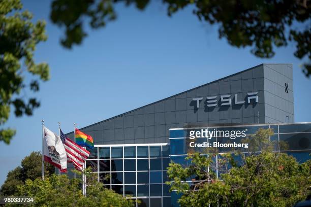 Flags fly outside of a Tesla Inc. Building in Fremont, California, U.S., on Wednesday, June 20, 2018. Tesla CEO Elon Musk said the company needed...