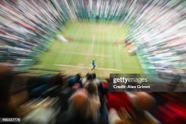 Roger Federer of Switzerland serves the ball to Benoit Paire of France during their round of 16 match on day 4 of the Gerry Weber Open at Gerry Weber...