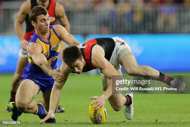 Jamie Cripps of the Eagles and Zach Merrett of the Bombers chase the ball during the round 14 AFL match between the West Coast Eagles and the...