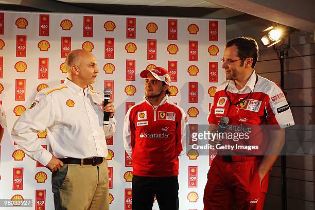 Ferrari Team Principal Stefano Domenicali talks alongside Ferrari driver Felipe Massa of Brazil and Richard Bracewell of Shell as they celebrate...