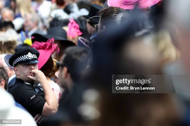 Police officer keeps an eye on the crowds during day 3 of Royal Ascot at Ascot Racecourse on June 21, 2018 in Ascot, England.