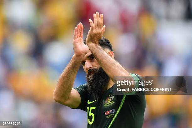 Australia's midfielder Mile Jedinak applauds the crowd after the final whistle during the Russia 2018 World Cup Group C football match between...