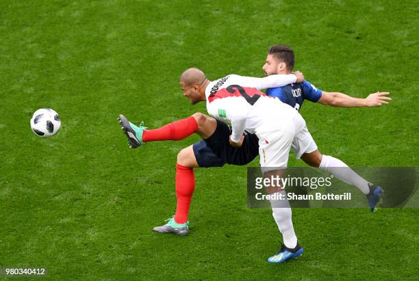Alberto Rodriguez of Peru wins a header over Olivier Giroud of France during the 2018 FIFA World Cup Russia group C match between France and Peru at...