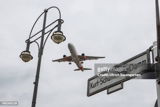 Low above the houses - landing approach of a passenger plane to the airport Berlin -Tegel.