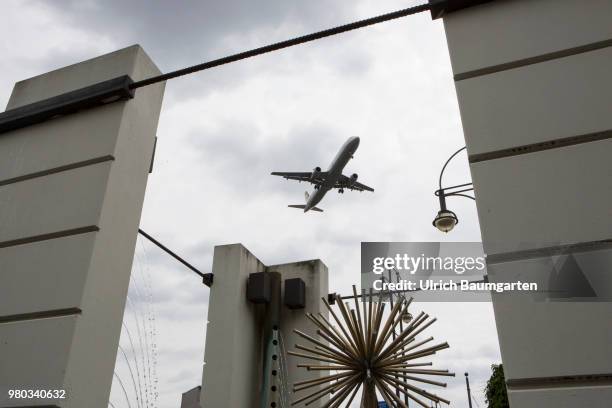 Low above the houses - landing approach of a passenger plane to the airport Berlin -Tegel.