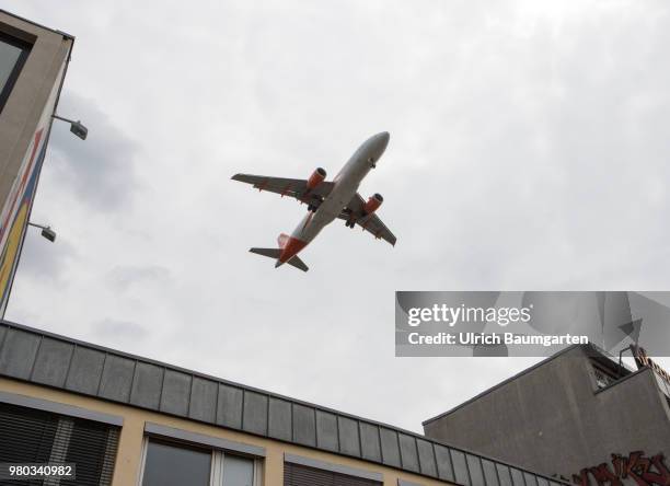 Low above the houses - landing approach of a passenger plane to the airport Berlin -Tegel.