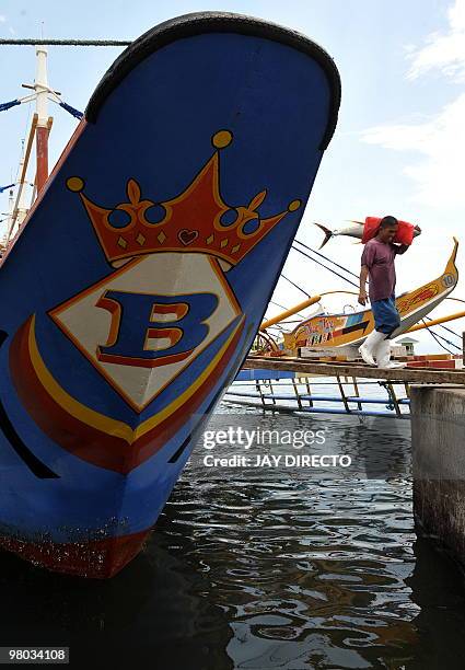 Worker in the southern Philippine city of General Santos unloads yellow fin tuna on March 25, 2010. The city is considered the tuna capital of the...