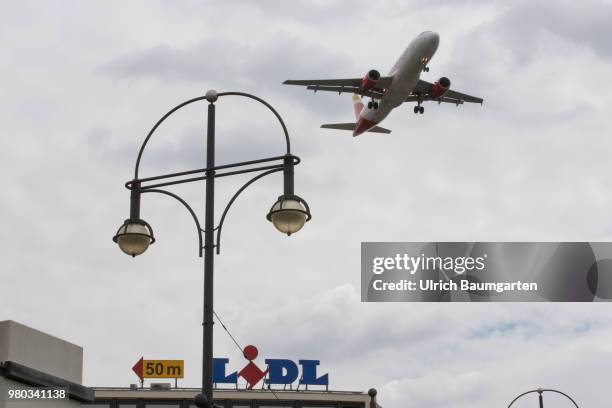 Low above the houses - landing approach of a passenger plane to the airport Berlin -Tegel.