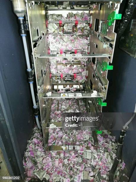 This picture taken on June 19 shows shredded Indian currency notes in 2000 and 500 rupee denominations after being eaten by rats in at ATM in...