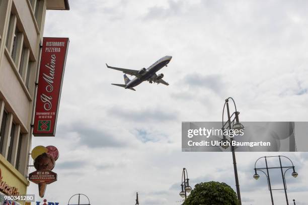 Low above the houses - landing approach of a passenger plane to the airport Berlin -Tegel.