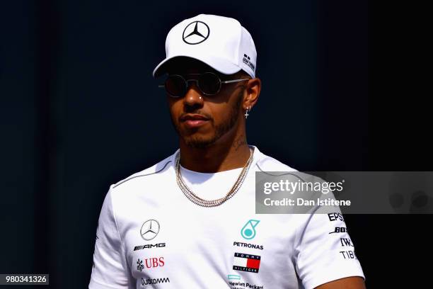 Lewis Hamilton of Great Britain and Mercedes GP walks in the Paddock during previews ahead of the Formula One Grand Prix of France at Circuit Paul...