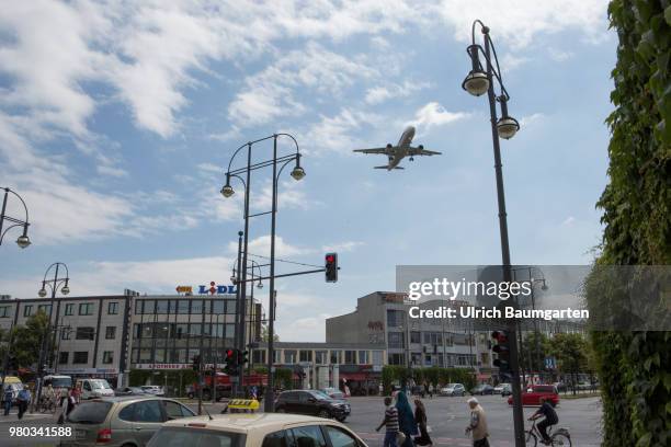 Low above the houses - landing approach of a passenger plane to the airport Berlin -Tegel.