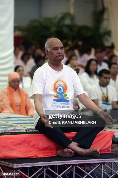 Indian President Ram Nath Kovind and Suriname's President Desi Bouterse take part in a yoga class on the 4th International Yoga Day in Paramaribo,...