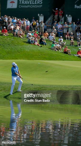 Webb Simpson plays a chip shot on the 15th hole during the first round of the Travelers Championship at TPC River Highlands on June 21, 2018 in...