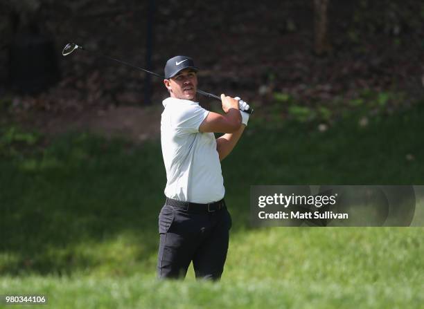 Brooks Koepka of the United States plays his shot from the 15th tee during the first round of the Travelers Championship at TPC River Highlands on...