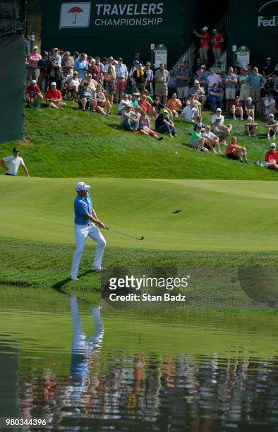 Webb Simpson plays a chip shot on the 15th hole during the first round of the Travelers Championship at TPC River Highlands on June 21, 2018 in...