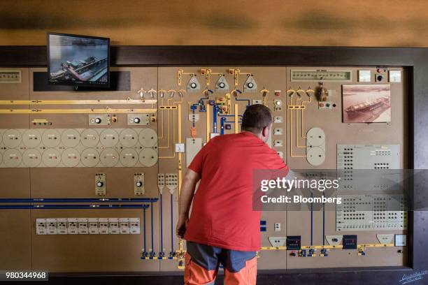 Worker uses a control panel in the grain silo control room at the Lecureur SA cereal plant in the Port of Rouen, in Val de la Haye, France, on...